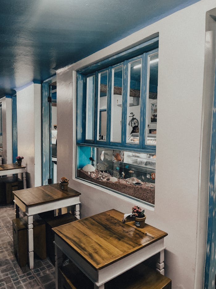 Interior of a charming coastal-themed cafeteria with wooden tables in Ilhabela, Brazil.